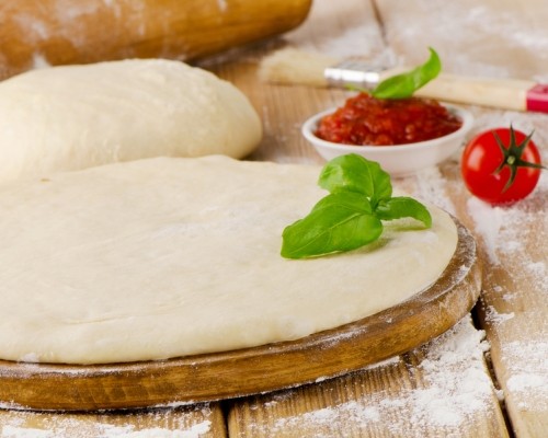 pizza dough with  fresh  basil