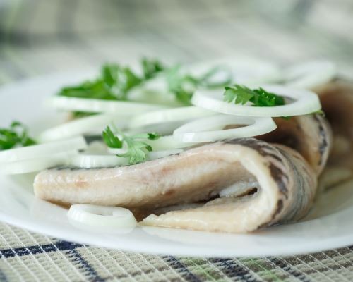 salted herring with onions on the table