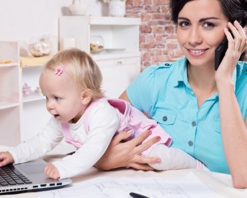 business woman with laptop and her baby girl